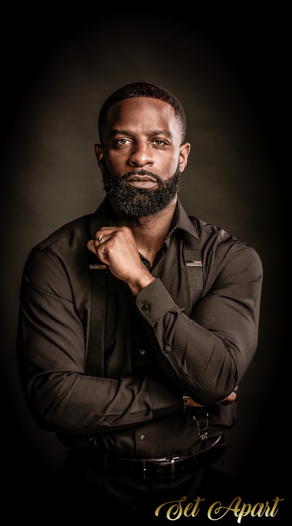 The owner of Set Apart Grooming Co., in black with suspenders