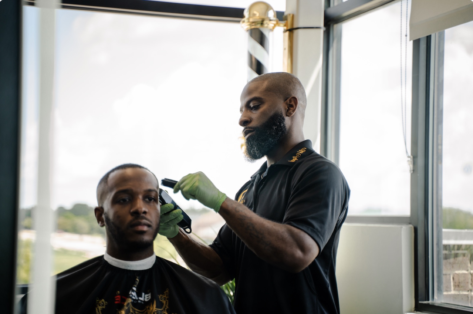 Barber lining up a client at the window chair