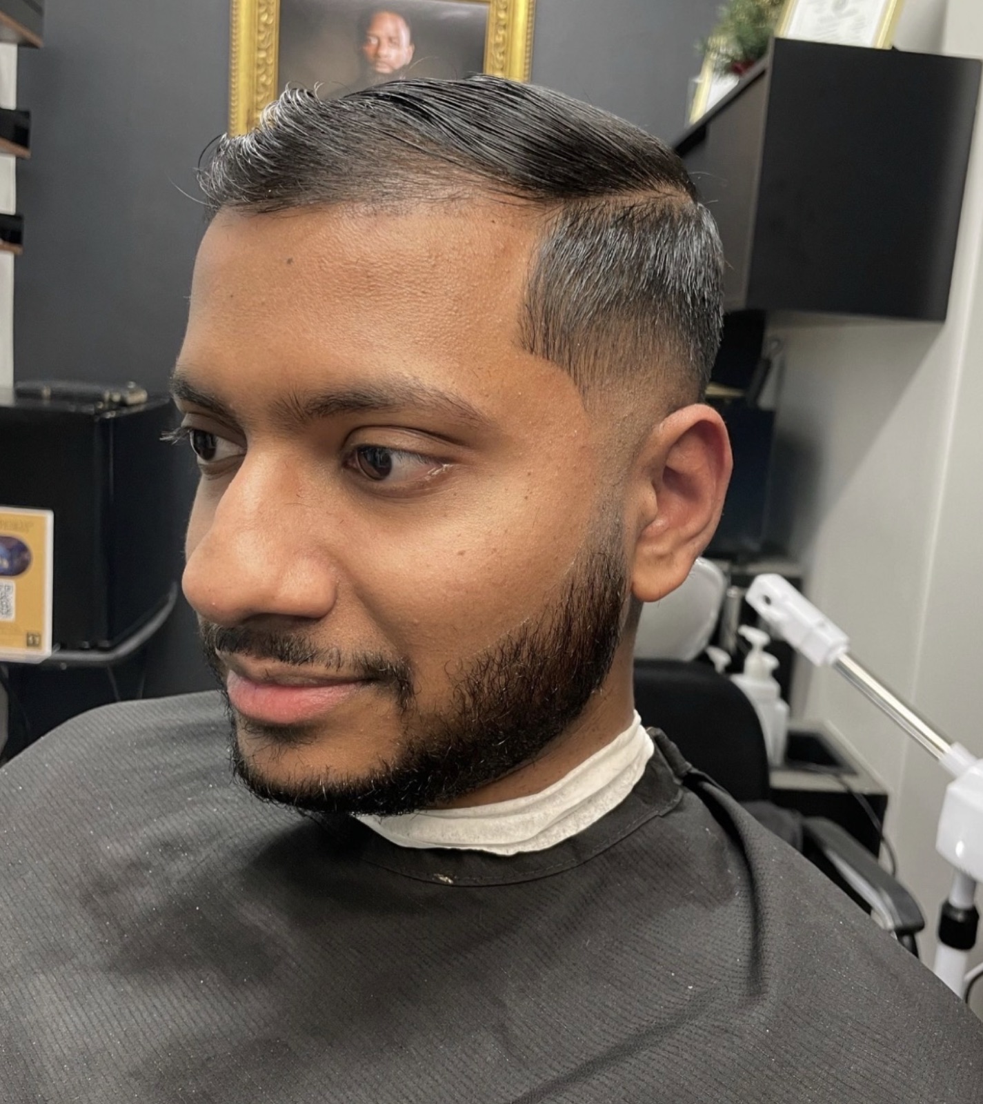 Finished cut — side-part fade with beard